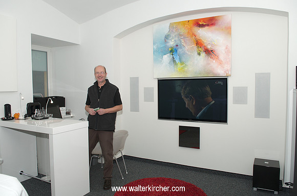 Peter Sambs with his new installed television set - It can be hidden behind the picture